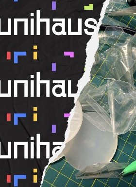Clear plastic packaging samples on a cutting mat next to the Unihaus wordmark
